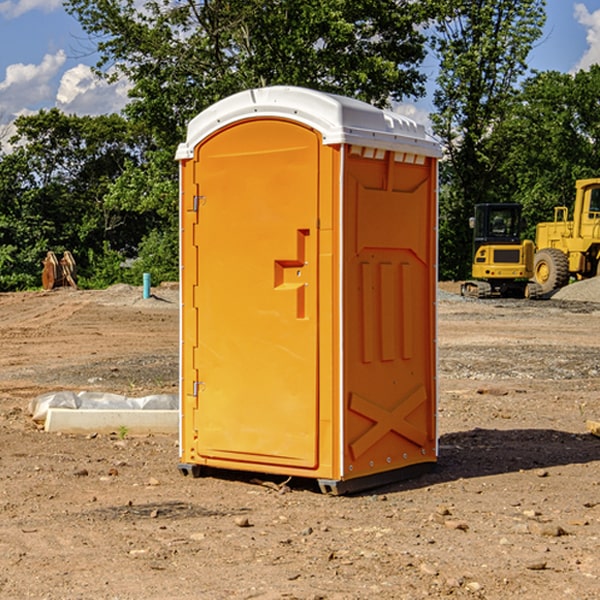 what is the cost difference between standard and deluxe portable restroom rentals in Harlan